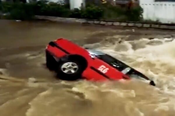 Hong Kong taxi driver and passenger escape as car plunges into sinkhole