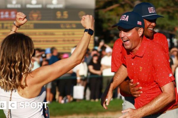 Keegan Bradley of the US celebrates clinching victory in the 2024 Presidents Cup with wife Jillian Stacey and team-mate Tony Finau