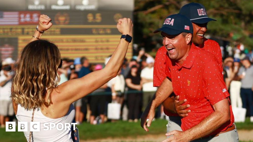 Keegan Bradley of the US celebrates clinching victory in the 2024 Presidents Cup with wife Jillian Stacey and team-mate Tony Finau