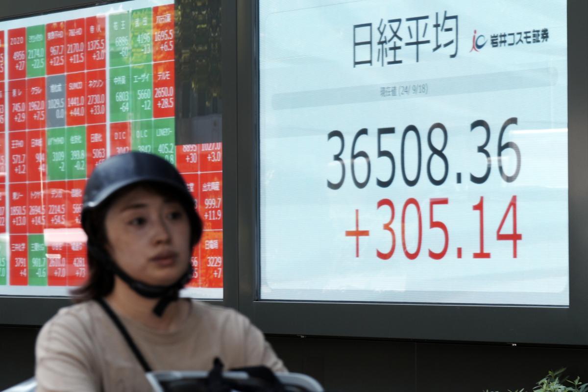 Global shares trade mixed ahead of Federal Reserve rate decision