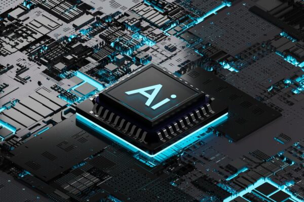 A black and teal AI chip on a black and teal motherboard.