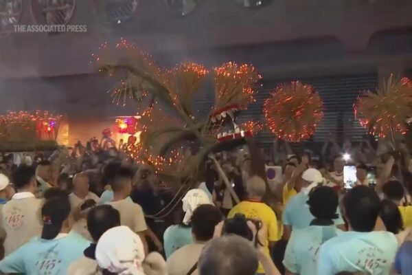 Hong Kong crowds watch traditional fire dragon parade