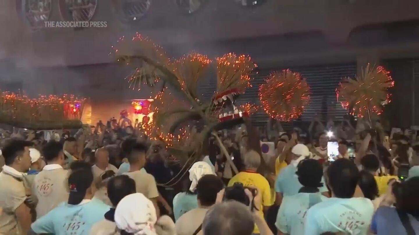 Hong Kong crowds watch traditional fire dragon parade