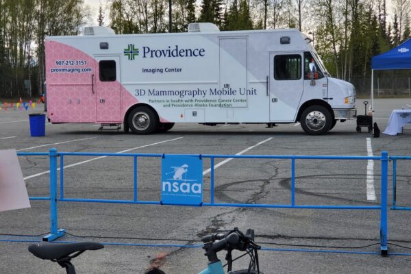 The Providence Imaging Center's Mammography Mobile Unit is parked at Bartlett High School on May 18, 2024, at the start area for the Gold Nugget Triathlon held the next day. (Photo by Yereth Rosen/Alaska Beacon)