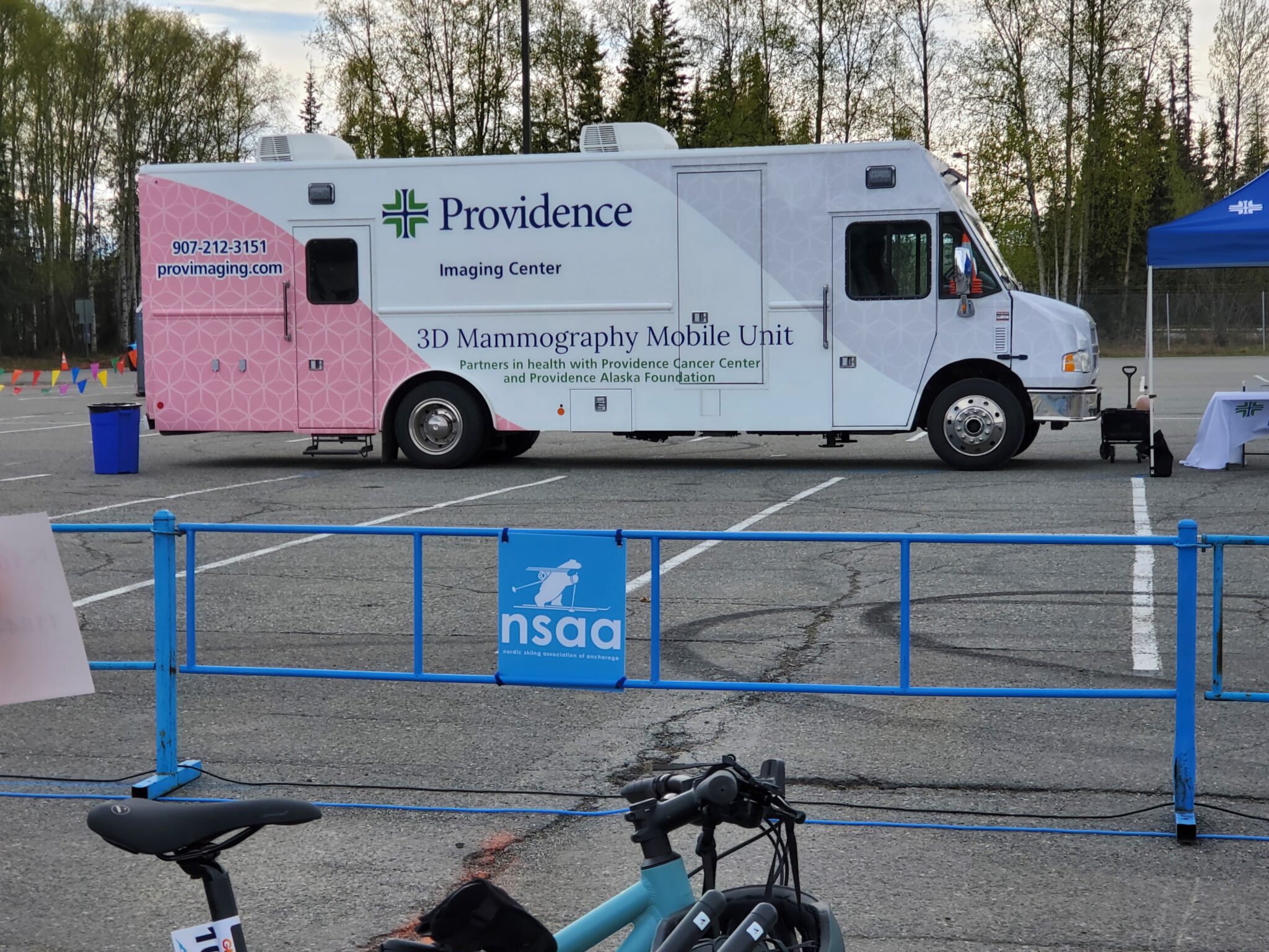 The Providence Imaging Center's Mammography Mobile Unit is parked at Bartlett High School on May 18, 2024, at the start area for the Gold Nugget Triathlon held the next day. (Photo by Yereth Rosen/Alaska Beacon)