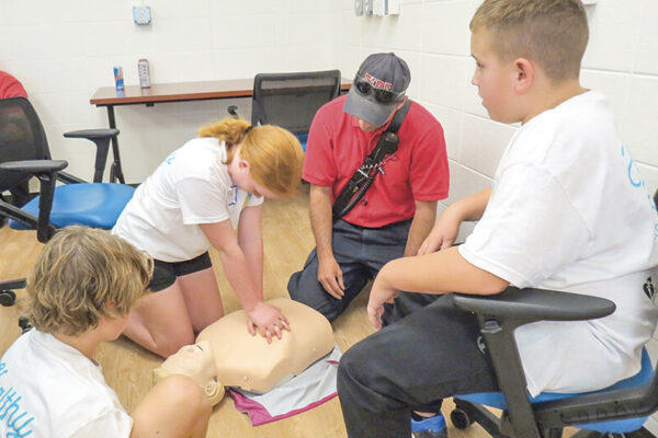 Under the direction of Laramie firefighters, students learned how to call 911 and to administer hands-only CPR ahead of the arrival of EMTs.