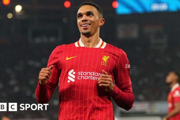 Trent Alexander-Arnold smiling while running on the pitch