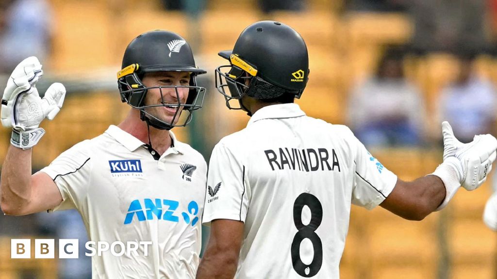 New Zealand batters Will Young and Rachin Ravindra celebrate victory in India