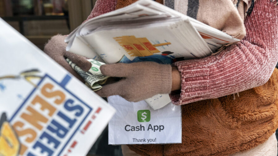 A vendor selling Street Sense, a local paper that covers issues related to the homeless and employs...