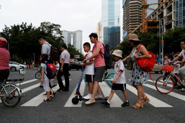 FILE PHOTO: Children and their parents are seen on their way to the school in Tianhe district in Guanghzou