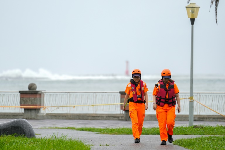 Waves break off Sizihwan Bay beauty spot in Kaohsiung as coast guard officers patrol ahead of the arrival of Super Typhoon Krathon (WALID BERRAZEG)