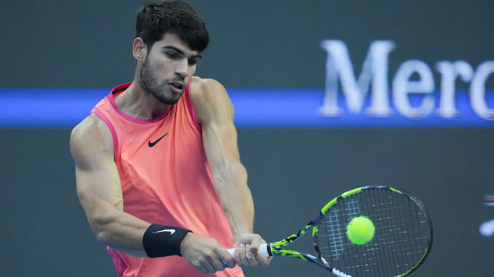Carlos Alcaraz of Spain returns a shot from Jannik Sinner of Italy during their men's singles finals match of the China Open tennis tournament, at the National Tennis Center in Beijing, Wednesday, Oct. 2, 2024. (AP Photo/Achmad Ibrahim)