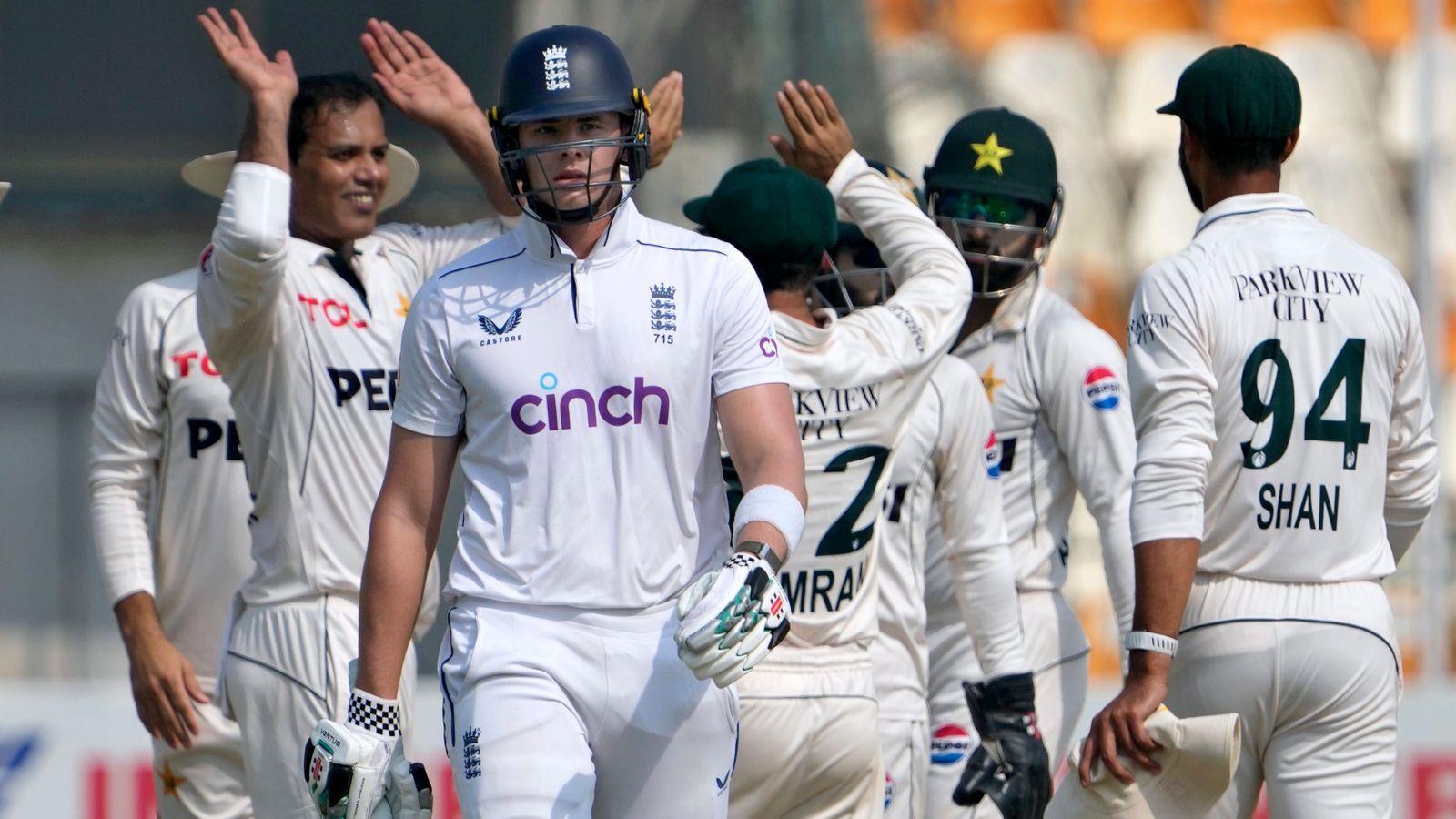 England's Jamie Smith, center front, walks off the field after he dismissed by Pakistan's Noman Ali, third left, during the fourth day of the second test cricket match between Pakistan and England, in Multan, Pakistan, Friday, Oct. 18, 2024. (AP Photo/K.M. Chaudary)