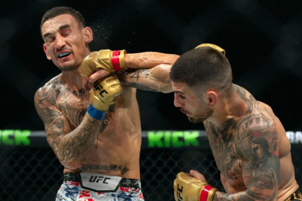 UFC 308: Ilia Topuria retains featherweight title as Max Holloway suffers career-first knockout defeat | WWE News Champion Ilia Topuria (right) battles Max Holloway during their mixed martial arts featherweight title bout at UFC Fight Night in Abu Dhabi