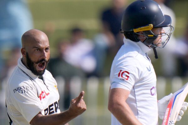 Pakistan's Sajid Khan, left, celebrates after taking the wicket of England's Ollie Pope, right, during the day one of third test cricket match between Pakistan and England, in Rawalpindi, Pakistan, Thursday, Oct. 24, 2024. (AP Photo/Anjum Naveed)