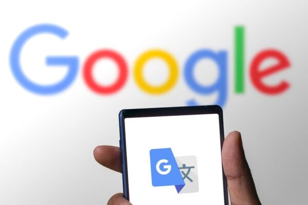 Google translate logo on a phone in front of a Google logo