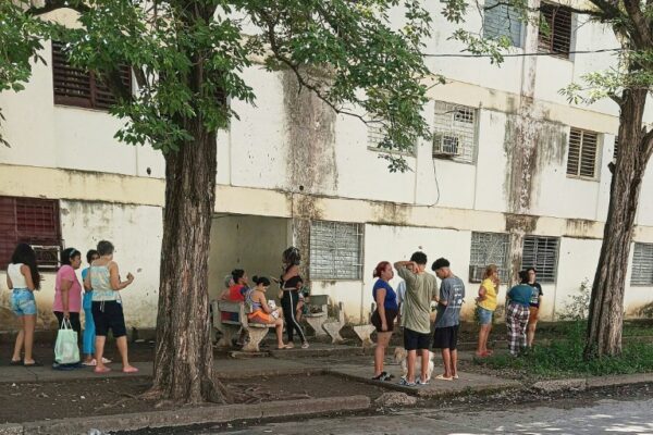 Residents stood outside their buildings after the earthquakes (Handout)