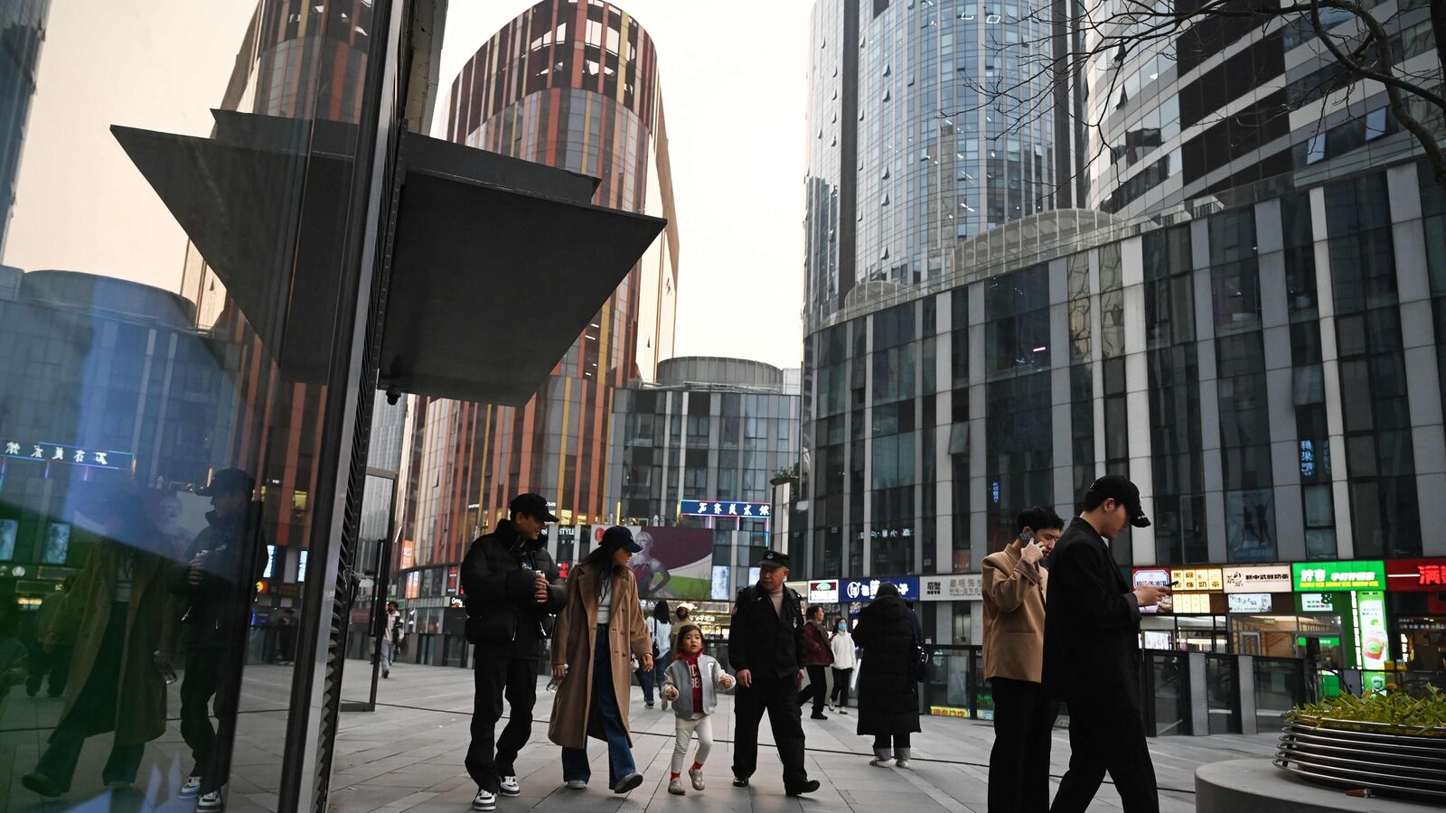 File image of people walk in a shopping mall in Beijing on November 8, 2024.