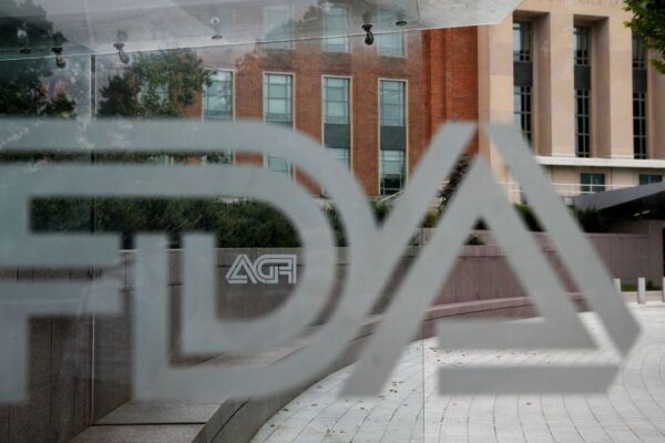 A U.S. Food and Drug Administration building is seen behind FDA logos at a bus stop on the agency's campus in Silver Spring, Md., on Aug. 2, 2018. (AP Photo/Jacquelyn Martin, File)