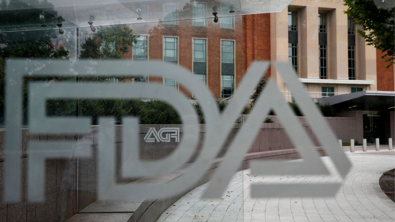 A U.S. Food and Drug Administration building is seen behind FDA logos at a bus stop on the agency's campus in Silver Spring, Md., on Aug. 2, 2018. (AP Photo/Jacquelyn Martin, File)