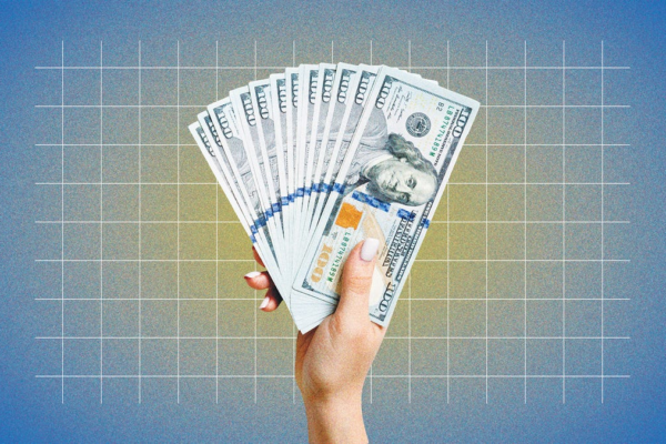 a hand holding multiple hundred dollar bills