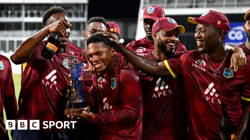 Keacy Carty of the West Indies celebrates his century with Brandon King.