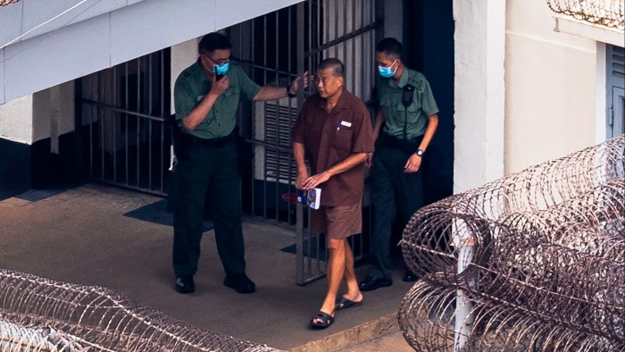 Jimmy Lai walks through the Stanley prison in Hong Kong