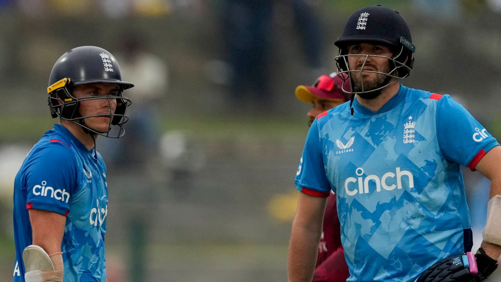 England's Jamie Overton, right, and Sam Curran look at the scoreboard during the first ODI cricket match against West Indies at Sir Vivian Richards Ground in North Sound, Antigua and Barbuda, Thursday, Oct. 31, 2024. (AP Photo/Ricardo Mazalan)