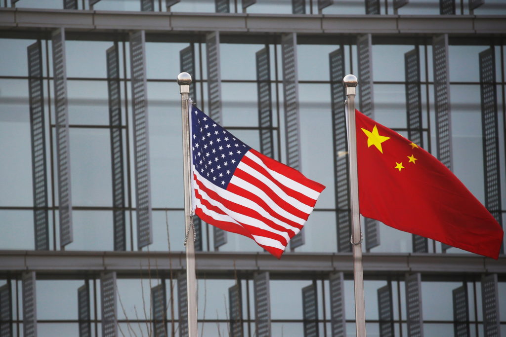 Chinese and U.S. flags flutter outside the building of an American company in Beijing