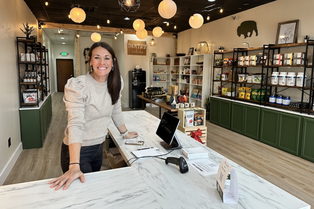 woman standing at counter in health supplement shop