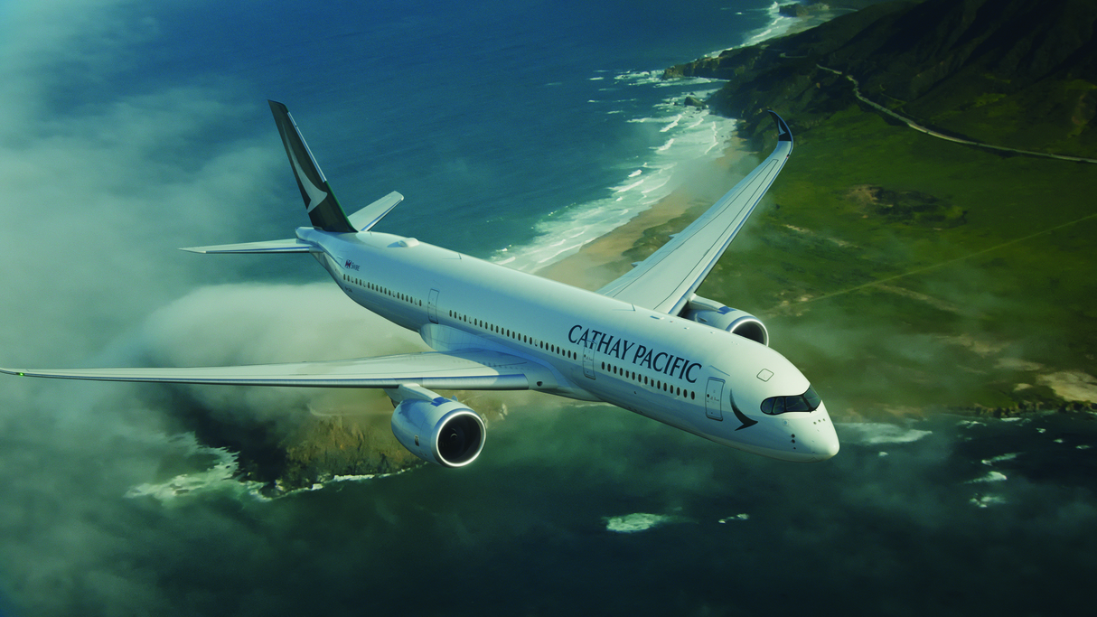 A Cathay Pacific A350 in flight over the coast.