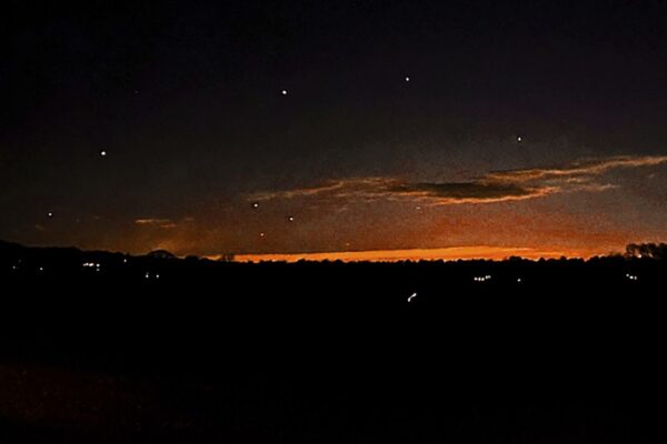 This photo provided by Trisha Bushey shows the evening sky and points of light near in Lebanon Township, N.J., on Thursday, Dec. 5, 2024. (Trisha Bushey via AP)