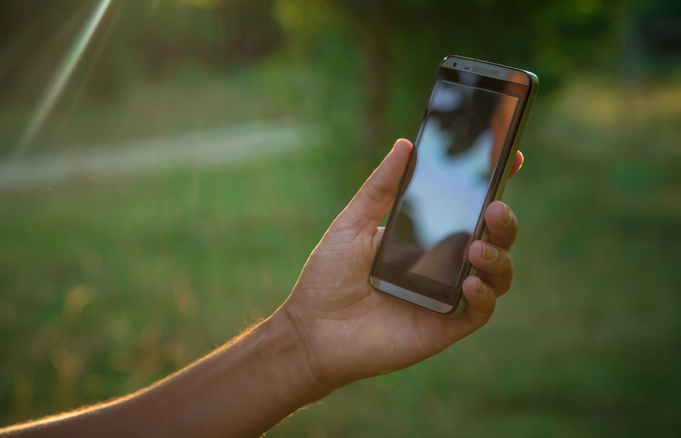 Hand holding a black smartphone.