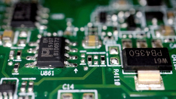 Semiconductor chips are mounted on a green printed circuit board.