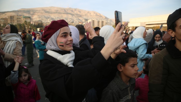 Crowds on Umayyad Square in Damascus celebrate the overthrow of the Assad regime in Syria