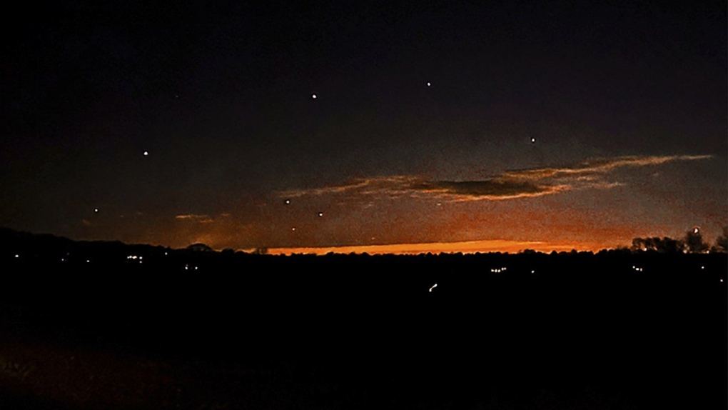 This photo provided by Trisha Bushey shows the evening sky and points of light near in Lebanon Township, N.J., on Thursday, Dec. 5, 2024. (Trisha Bushey via AP)