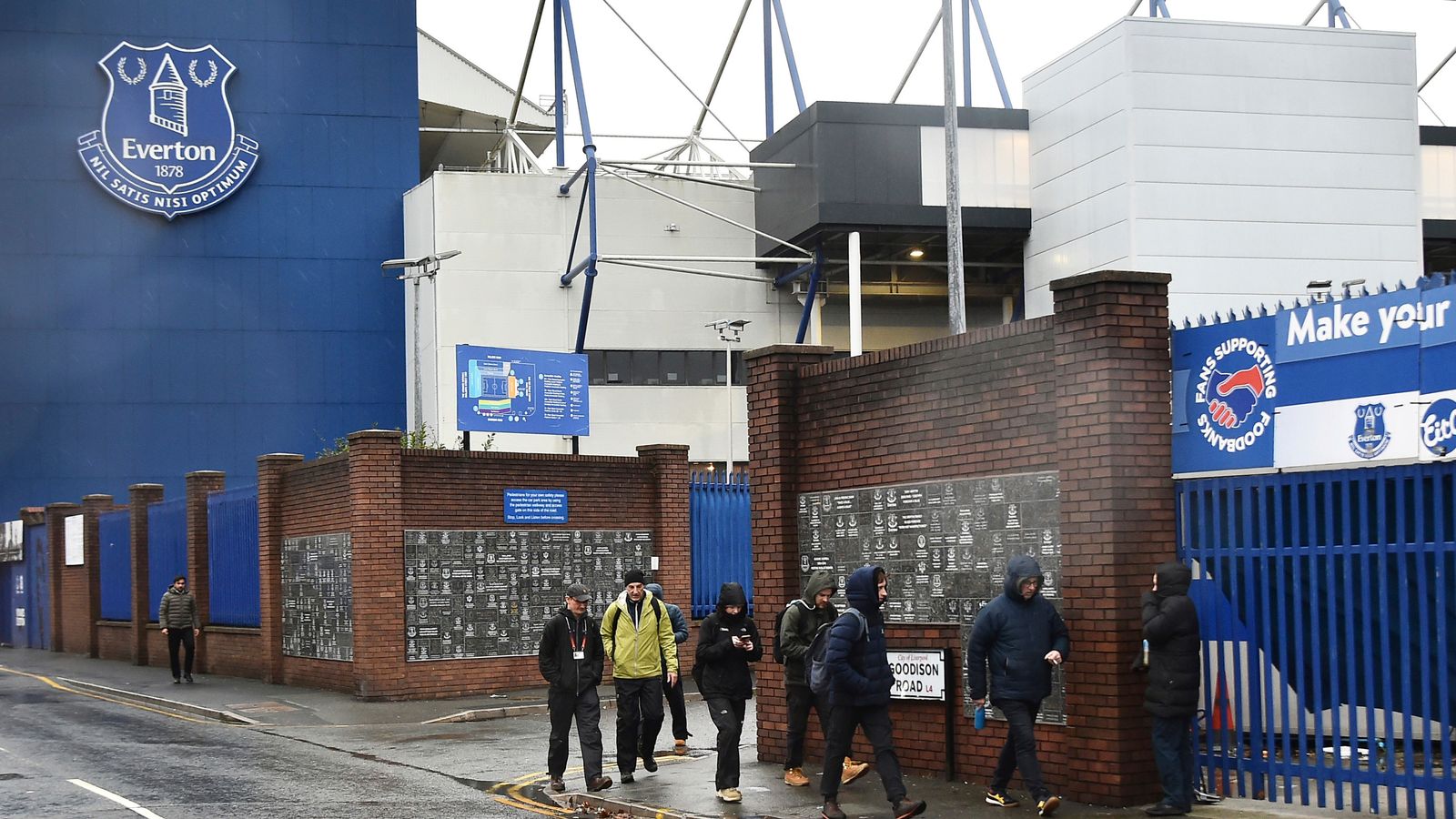 People walk outside Goodison Park as the Premier League soccer match between Everton and Liverpool is called off due to storm Darragh at Goodison Park, in Liverpool, England, Saturday Dec 7, 2024. (AP Photo/Rui Vieira)