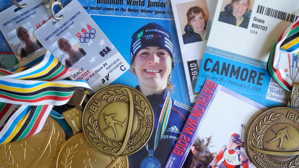 Biathlon competition medals, credentials, and media clippings belonging to Grace Boutot, silver medalist in Youth World Championships in 2009, are displayed for a photograph at her home, Oct. 17, 2024, in Boston. (AP Photo/Steven Senne)