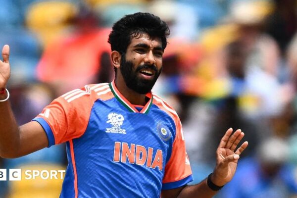 India fast bowler Jasprit Bumrah with his arms raised