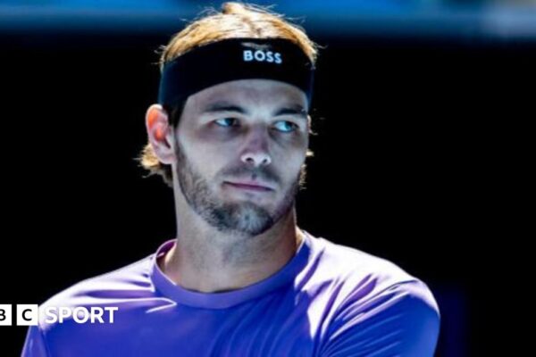 Australian Open 2025: Taylor Fritz to donate first-round prize money to Los Angeles wildfire relief funds Taylor Fritz writes a message on a video camera lens after winning against Chile's Cristian Garin