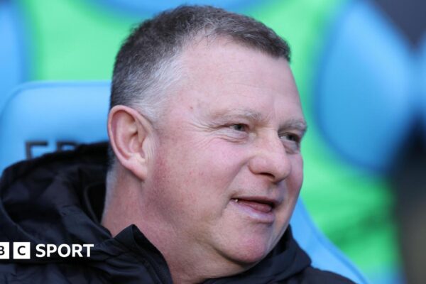 Mark Robins sitting in the dugout during his time as Coventry City boss