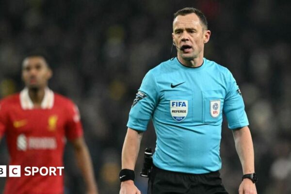 Referee Stuart Attwell is talking during Tottenham's League Cup game against Liverpool