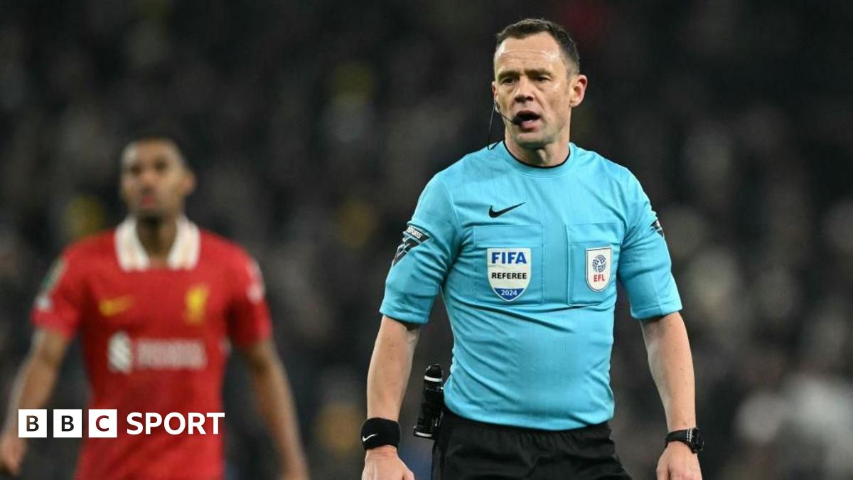 Referee Stuart Attwell is talking during Tottenham's League Cup game against Liverpool