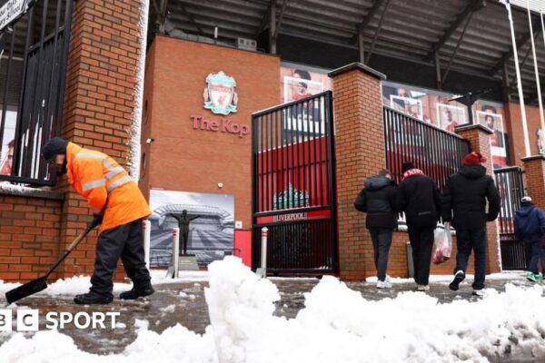 Liverpool v Manchester United on after final safety inspection at Anfield Workers clear snow outside Liverpool's Anfield Stadium