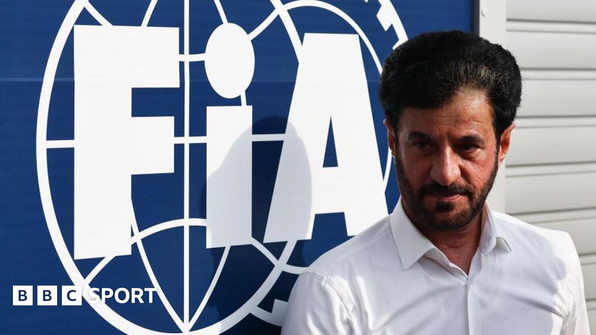 Mohammed Ben Sulayem stands in front of an FIA sign