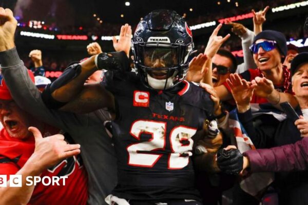 Joe Mixon celebrates scoring a touchdown against the Los Angeles Chargers, surrounded by Houston Texans fans