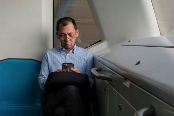 Photo: A man is seen texting on his phone....