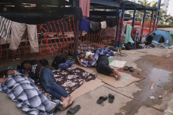 Migrants sleep on the side of a street in Acapulco, Mexico, Monday, Jan. 6, 2025. (AP Photo/Bernardino Hernandez)