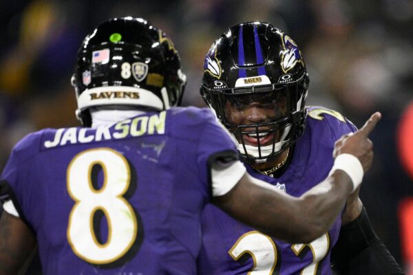 Baltimore Ravens running back Derrick Henry (22) is congratulated by teammate Lamar Jackson (8) after scoring during the second half of an NFL football game against the Cleveland Browns Saturday, Jan. 4, 2025, in Baltimore. (AP Photo/Nick Wass)