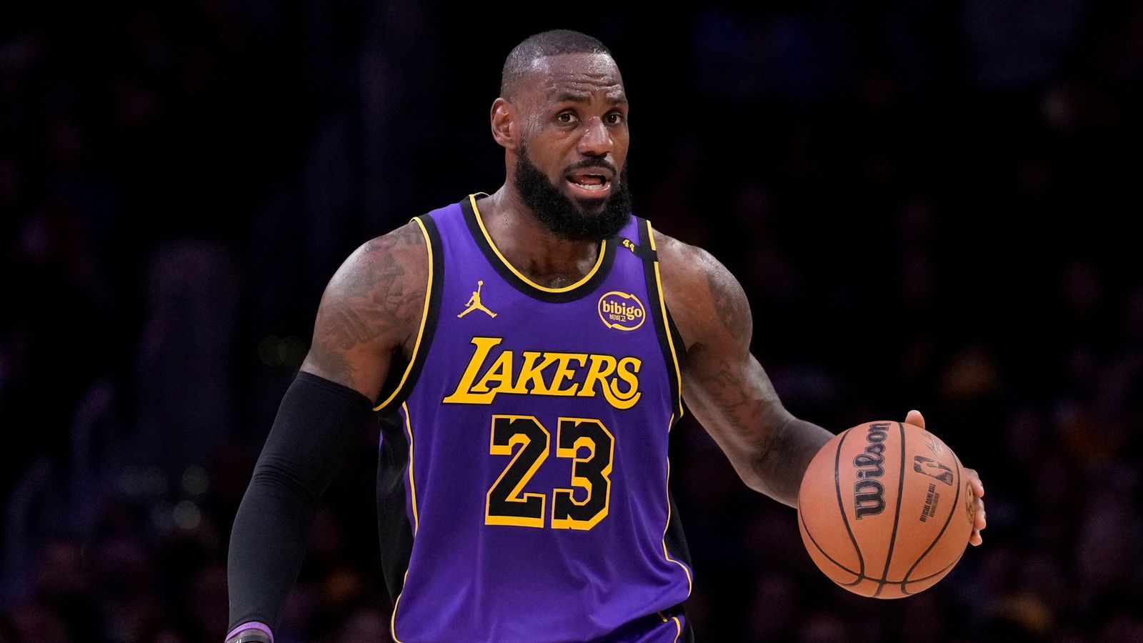 Los Angeles Lakers forward LeBron James dribbles during the first half of an NBA basketball game against the Atlanta Hawks, Friday, Jan. 3, 2025, in Los Angeles. (AP Photo/Mark J. Terrill)